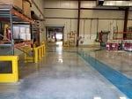 polished concrete floor with blue walkway in manufacturing facility